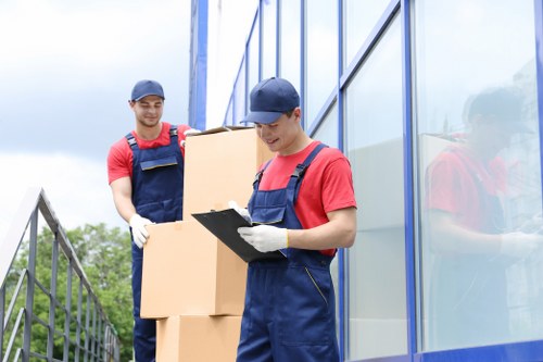 Professional movers handling household items in a Chiswick flat