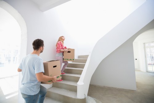 Packed moving boxes and furniture prepared for a removal van in Chiswick