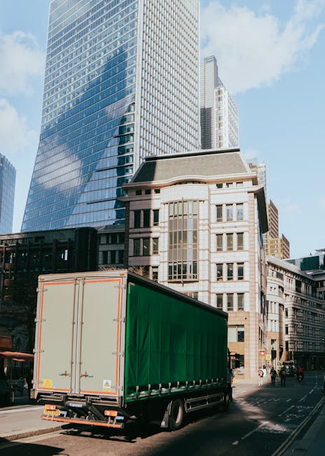 Inside a residential property, a professional moving team from Man With a Van Chiswick is engaged in the furniture transport and home relocation process. The image shows a spacious room with a doorway